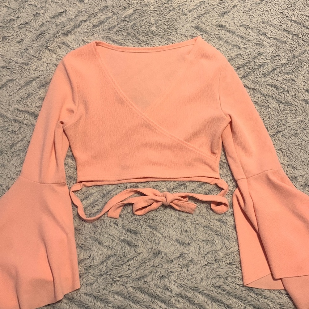 Pink cropped flare long sleeve top with wrap around waist straps